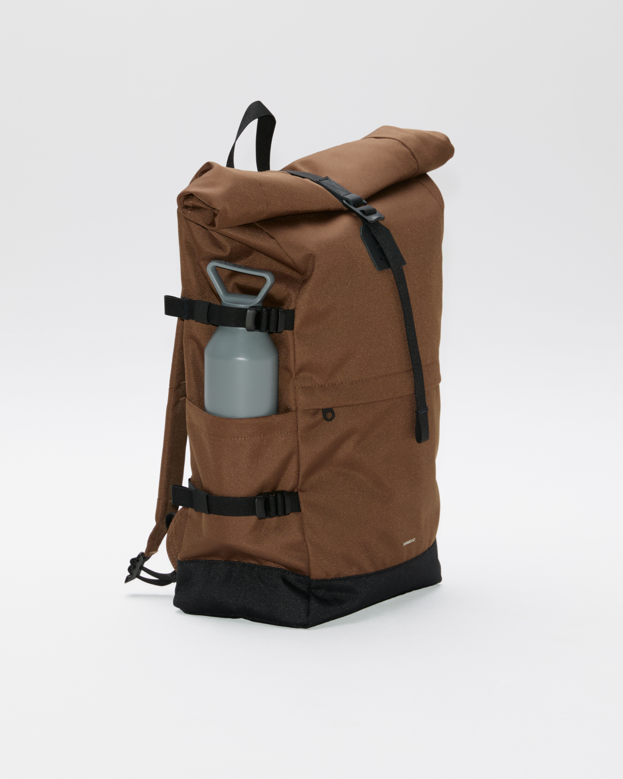 Rucksack, Sandqvist ICON Rolltop Backpack 16”, brown. Seitenansicht, vordere Schnalle, Griff und Schultergurt.