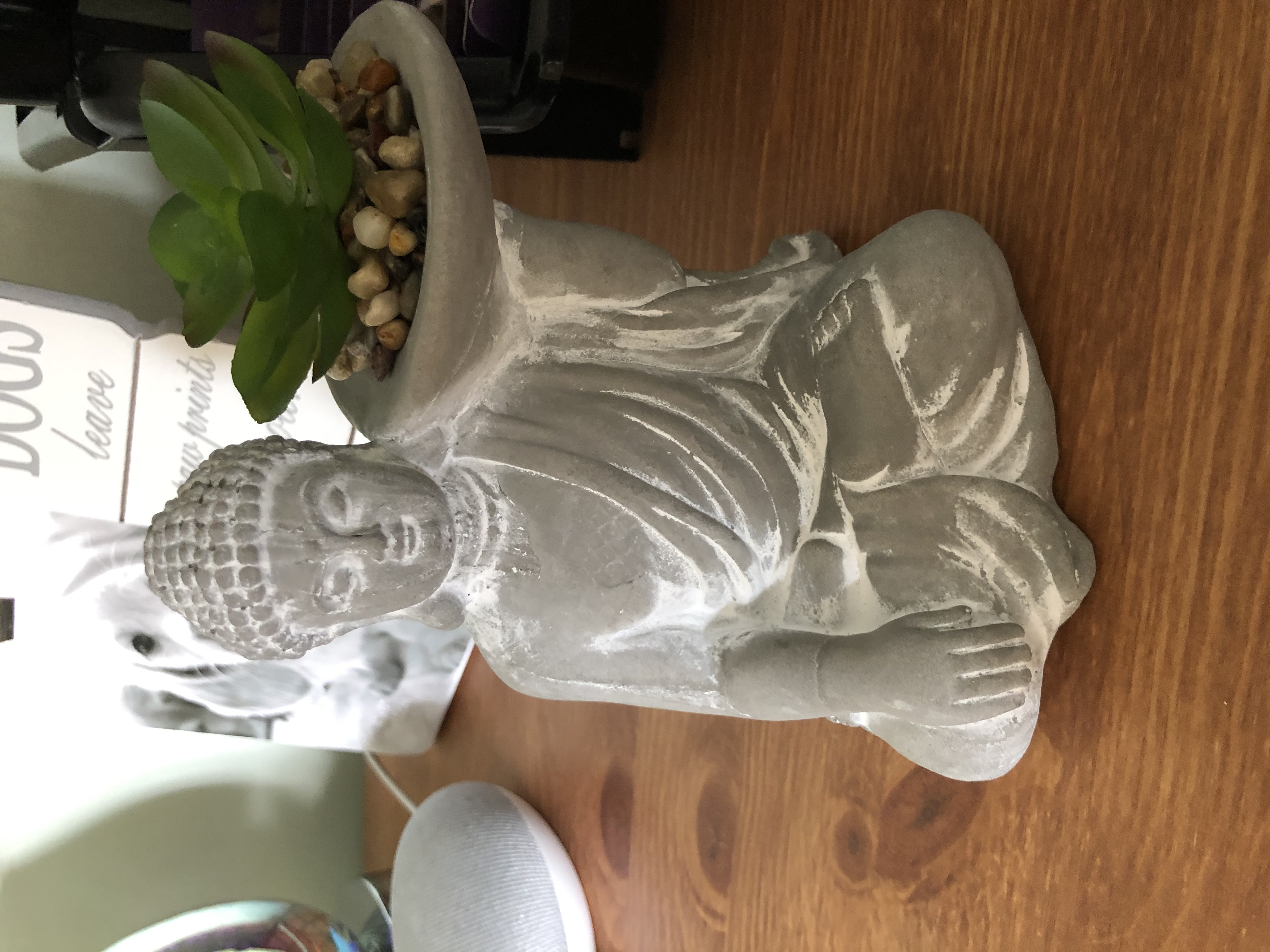 Cement Budda with bowl on shoulder.