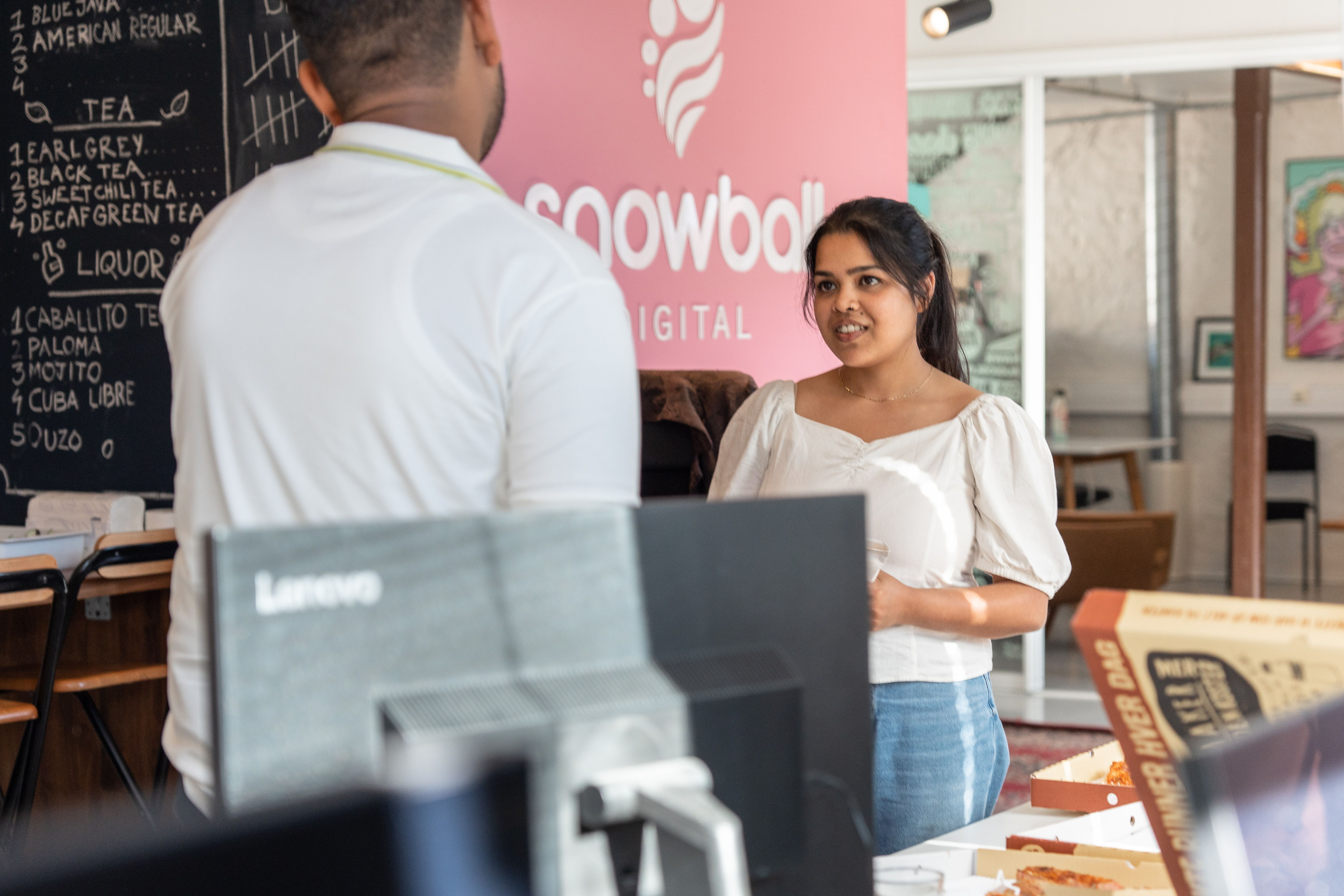 Image of two employees chatting in Snowball office