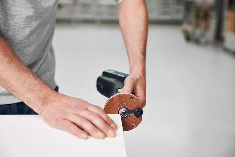 Festool OFKC 500 trimming the edge of a panel