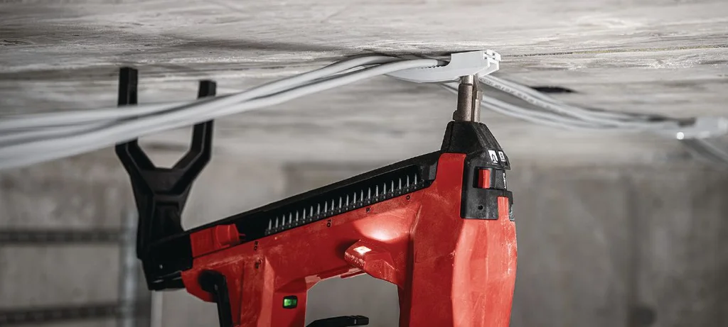 Electrician fixing to a concrete ceiling with the Hilti BX 4-22