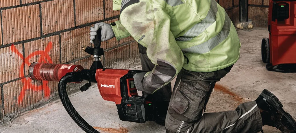 Plumber coring through a concrete wall with the Hilti DD 150-U-22