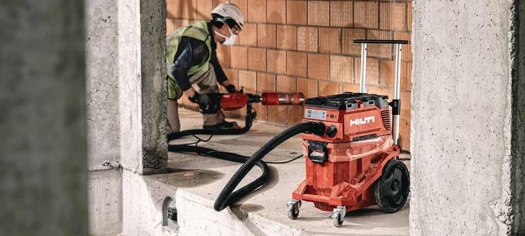 Hilti VC 40M-X connected to a power tool on site
