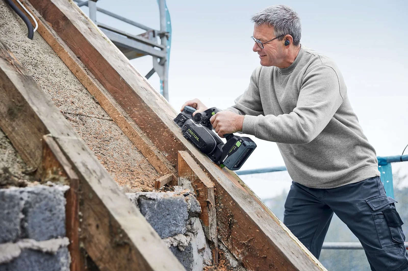 Carpenter planing a roof timber with the HLC 82